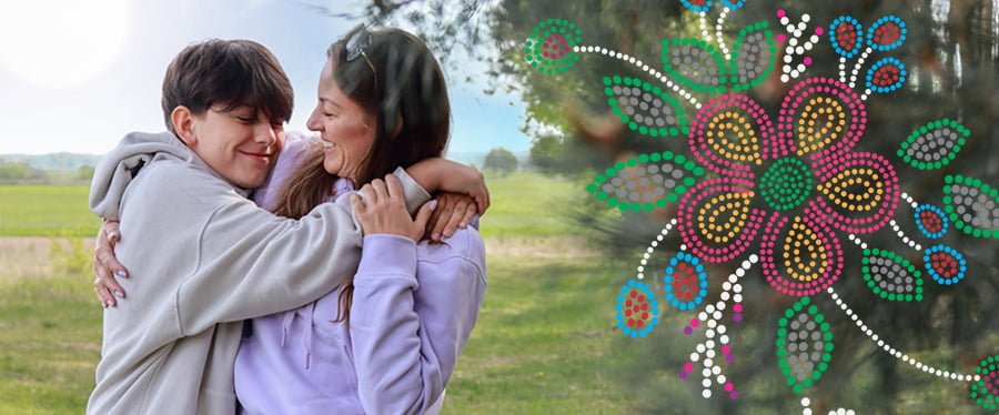 News Mobile Header Mother and son embracing one another outside with Metis style beadwork motif overlay